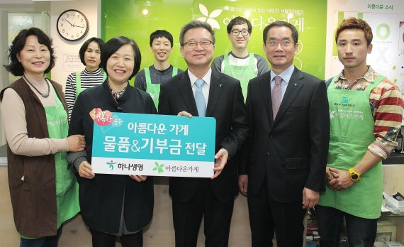 ▲ 하나생명 임직원들이 아름다운가게에서 지난 5일 열린 하나생명과 함께하는 아름다운 특별전에서 판매된 재활용품 700여점과 함께 300만원의 기부금을 전달했다. 물품과 기부금 전달 후 (왼쪽 두번째부터) 아름다운가게 정낙섭 국장, 하나생명 권오훈 대표, 주재중 전무와 자원봉사자들이 기념촬영을 하고 있다.