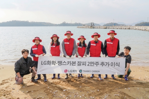 LG화학 임직원과 한국수산자원공단 직원들이 여수 대경도 앞바다에서 잘피 2만주 추가이식 기념 촬영을 하고 있다.[사진=LG화학]