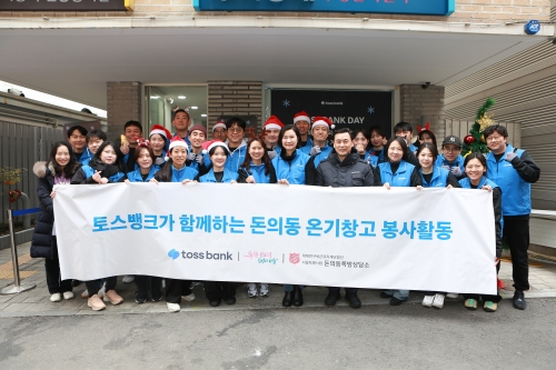 지난 20일 서울 종로구 돈의동 쪽방촌을 찾은 이은미 토스뱅크 대표(앞줄 왼쪽에서 7번째)와 정상훈 서울시 복지실장(앞줄 왼쪽에서 8번째), 토스뱅크 임직원들이 단체사진을 찍으며 환하게 웃고 있다. [사진=토스뱅크]