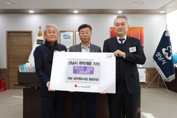 신상진 성남시장이 26일 시청에서 한대현 성남섬유제조사업 협동조합 이사장(맨 오른쪽), 홍기섭 홍한섬유산업 대표 등으로부터 어르신 방한용품을 전달받고 있다.