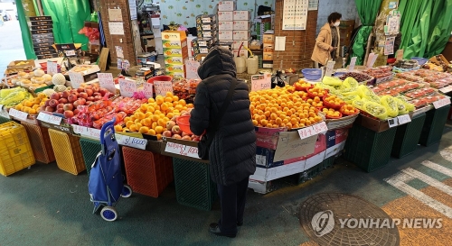 설 명절을 앞두고 이상기후 여파 등으로 차례상 비용이 상승한 가운데 13일 서울 시내 한 전통시장에서 이용객들이 과일 등 농산물을 살펴보고 있다.