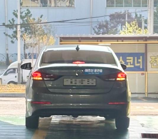 한국교통안전공단 사하자동차검사소 방문고객이 '고령운전자 표지'를 배부받아 자동차 후면에 부착한 모습.