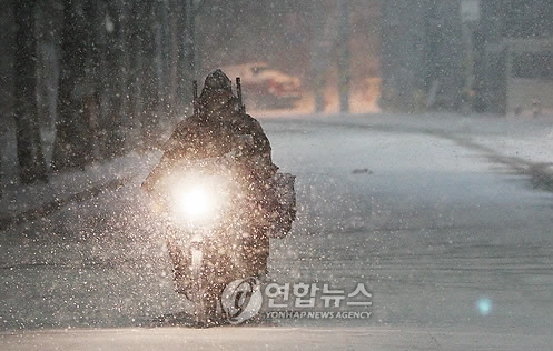 기상청이 4일 오전 5시30분 서울시에 대설주의보를 발령한 가운데 통제된 삼청터널길 인근으로 한 오토바이가 지나고 있다.